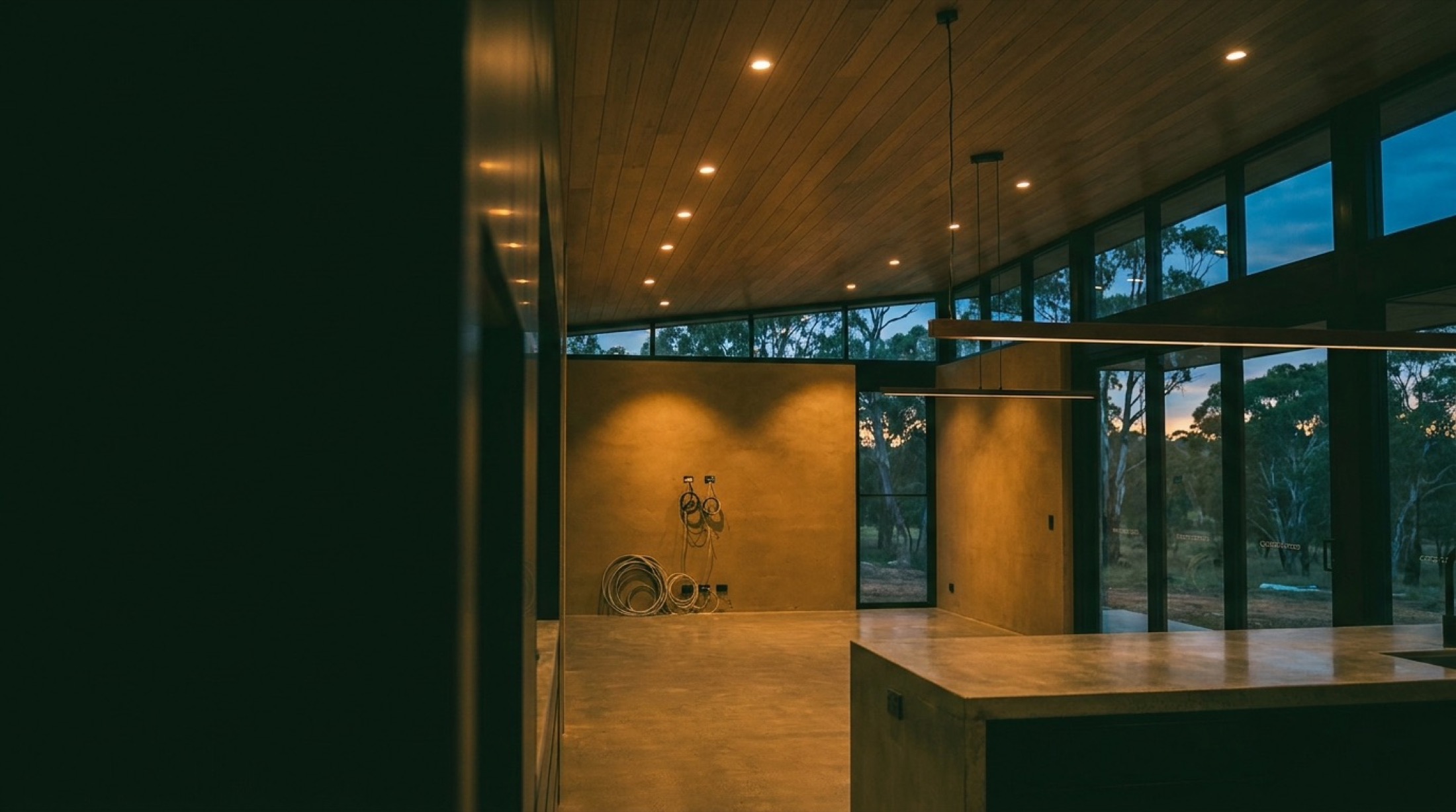 A modern kitchen and living space lit at night