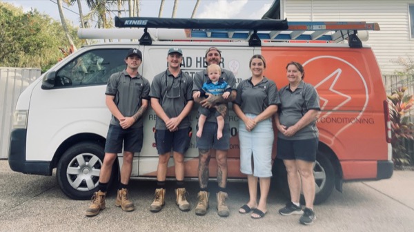 The Brad Hehir Electrical team and family standing beside the branded work van