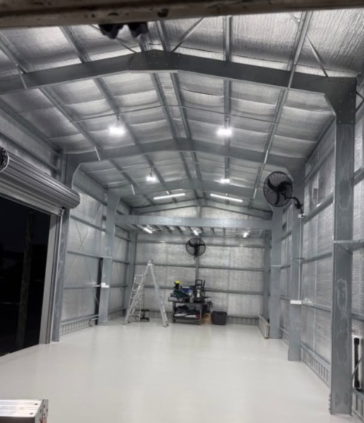The inside of a large shed with the lights switched on