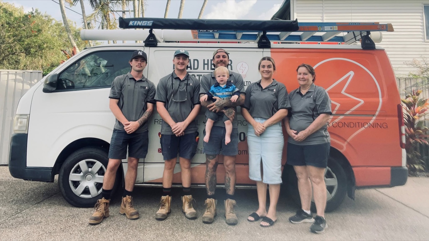 The Brad Hehir Electrical team and family standing beside the branded work van