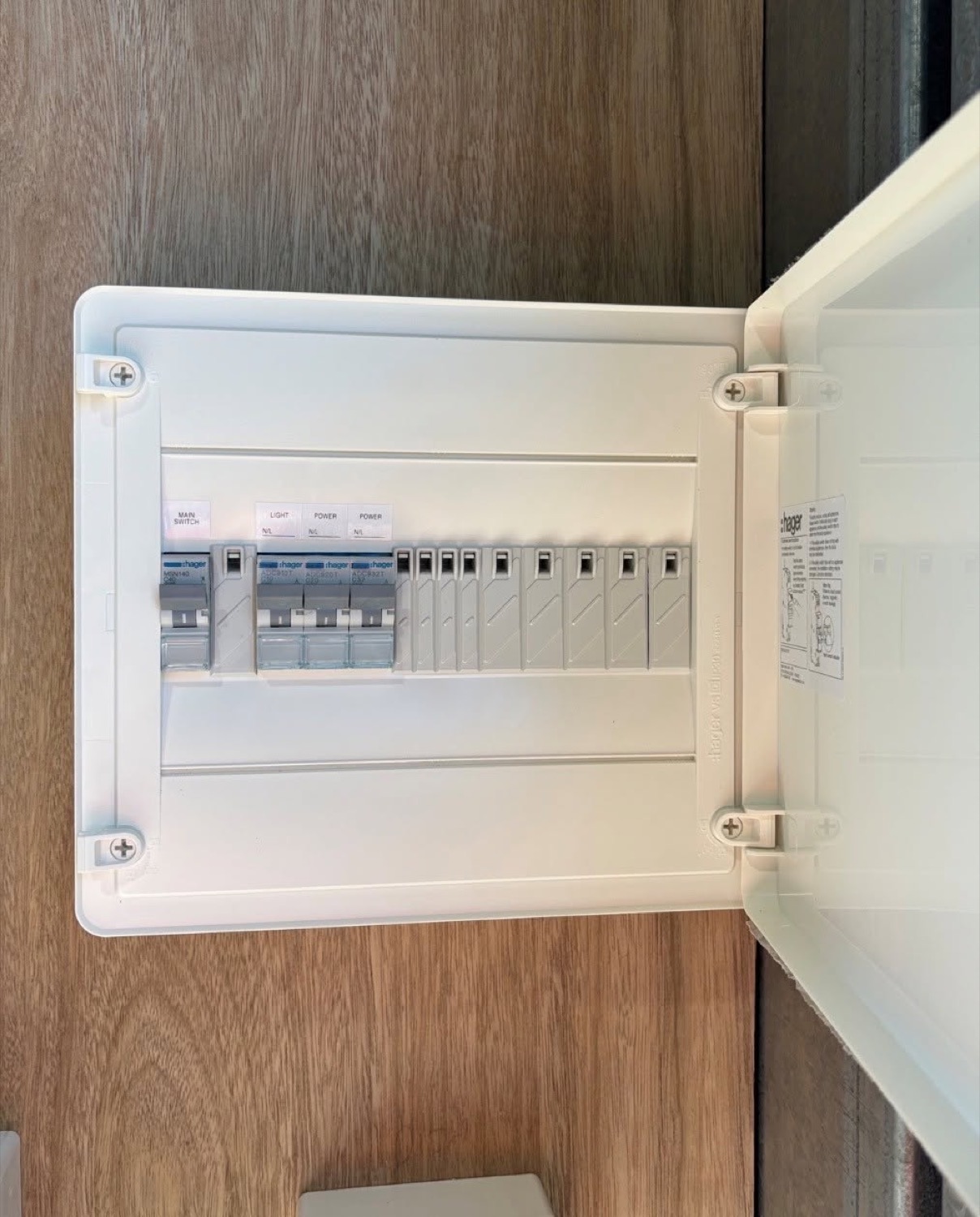 An open switchboard with rows of circuit breakers and wiring